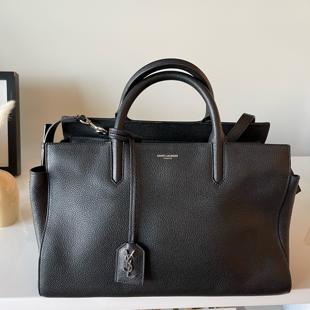 Black YSL, lightly used. Has one mark on the handle you can barley see.